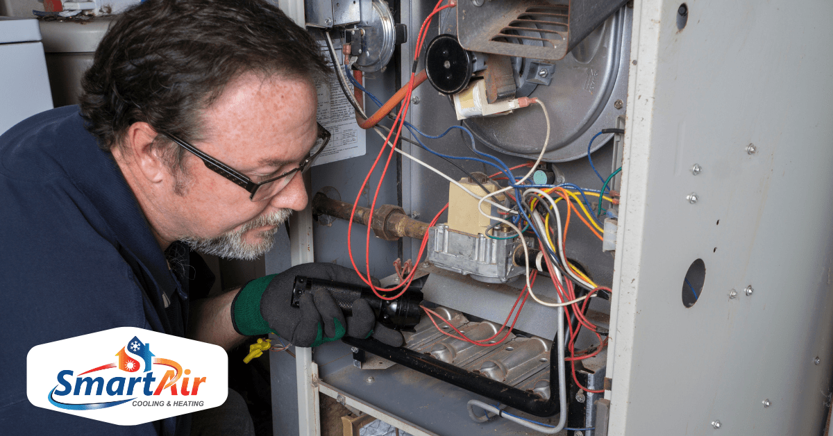 A technician fixing a furnace.